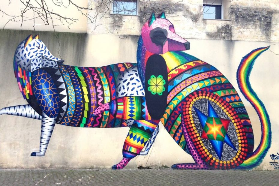 2 multicolored animals painted onto a wall in grafitti style